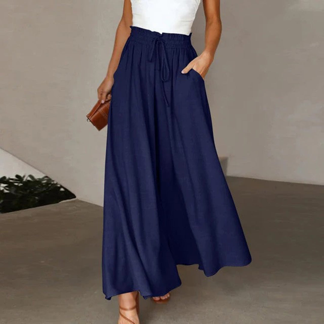 Pantalon taille haute, ceinture élastiquée avec cordon de serrage – coupe évasée – avec poches – long et aérien