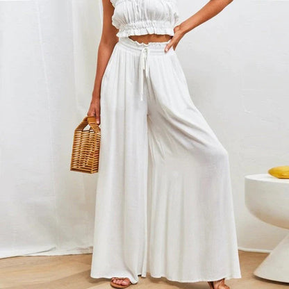 Pantalon taille haute, ceinture élastiquée avec cordon de serrage – coupe évasée – avec poches – long et aérien