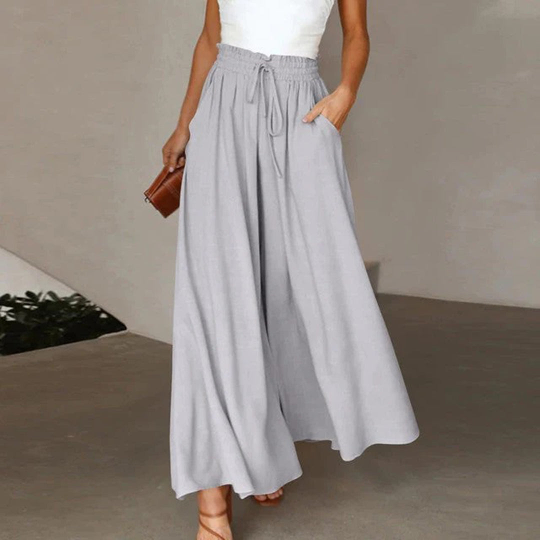 Pantalon taille haute, ceinture élastiquée avec cordon de serrage – coupe évasée – avec poches – long et aérien