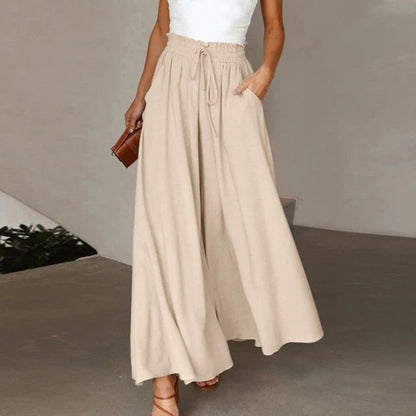 Pantalon taille haute, ceinture élastiquée avec cordon de serrage – coupe évasée – avec poches – long et aérien