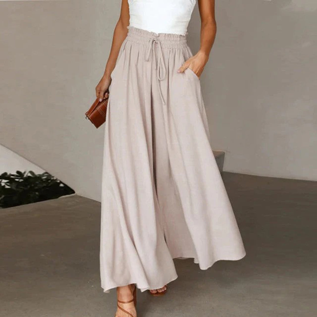 Pantalon taille haute, ceinture élastiquée avec cordon de serrage – coupe évasée – avec poches – long et aérien