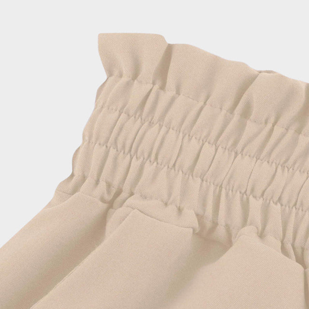 Pantalon taille haute, ceinture élastiquée avec cordon de serrage – coupe évasée – avec poches – long et aérien