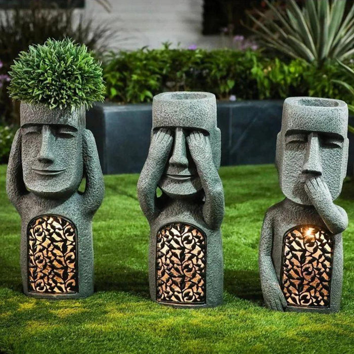 Pot de fleurs à visage sculpté
