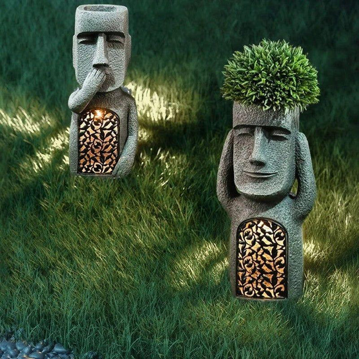 Pot de fleurs à visage sculpté
