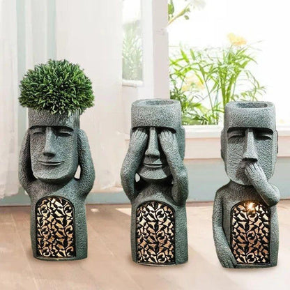 Pot de fleurs à visage sculpté